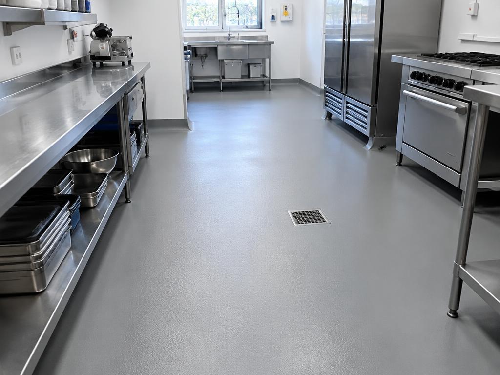 Seamless tiled commercial kitchen floor after polyurethane cement coating